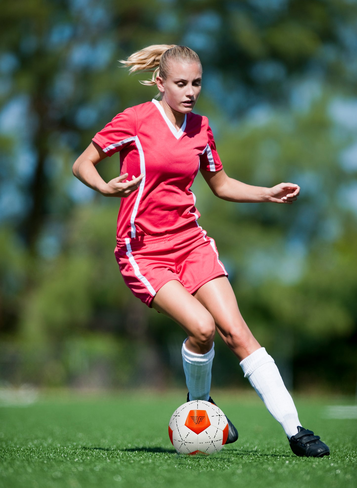 Woman playing soccer with a Flynn Ball